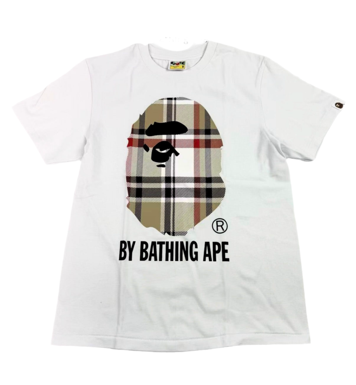 White t-shirt with a graphic design featuring a checkered face and 'By Bathing Ape' text on a white background.